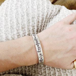 May include: Silver bracelet with the inscription "remarkably made".
