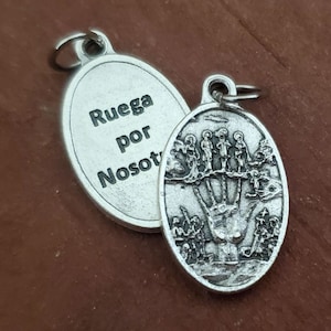 May include: Silver oval pendant with a hand and people on one side and the text "Ruega por Nosot" on the other side.
