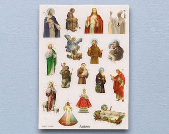 May include: A sheet of stickers featuring various religious figures, including Jesus, saints, and angels. The stickers are colorful and detailed, with each figure surrounded by a halo. The word "Autom" is printed at the bottom.