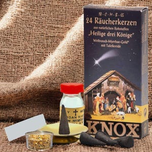 May include: A box of 24 incense sticks with a nativity scene on the front. The box is labeled "24 Räucherkerzen" and "Heilige drei Könige". There is also a small bottle of incense oil and a white card.