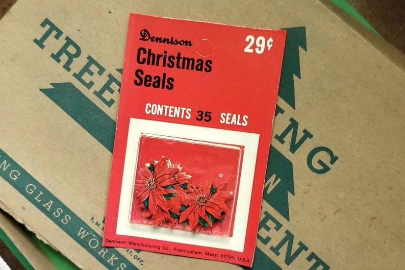 May include: A red and white package of Dennison Christmas Seals with a picture of red poinsettia flowers. The package says "Dennison Christmas Seals" and "Contents 35 Seals". The price is 29 cents.