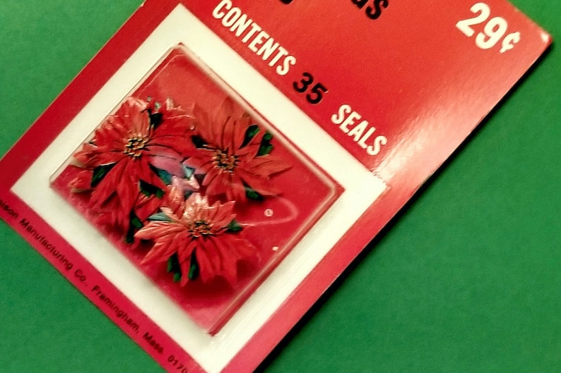 May include: A red and white package of 35 Christmas seals featuring a red poinsettia design. The package says "Contents 35 Seals" and "29&cent;".