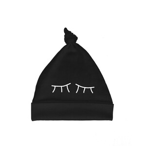 Organic cotton baby hat with screen printed sleepy eyes design by Bugged Out, made in the USA