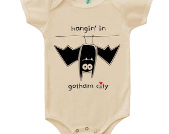 Organic cotton short sleeve baby one piece with screen printed hanging in gotham city bat design by Bugged Out, made in the USA