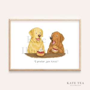 May include: A framed print showing two cartoon dogs, one golden and one brown, at a table. The golden dog has a dessert with cream, while the brown dog is eating a sandwich. The text "I prefer jam first" is below the image.