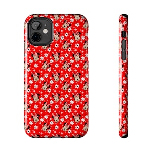 May include: A red phone case featuring a repeating pattern of Minnie Mouse faces and white daisies. The case has a glossy finish and a black camera lens cutout. The side view shows the same pattern.