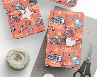 May include: Wrapped gifts featuring a car-themed design on coral paper, tied with twine and decorated with star and heart-shaped tags. A ball of twine, scissors, and blank tags are also visible.