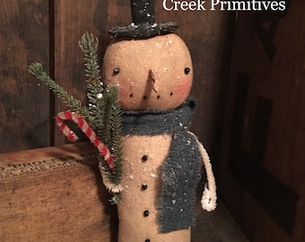 May include: A handmade snowman doll with a black top hat, a blue scarf, and a candy cane. The doll is made of burlap and has a rustic look. (c) 2018 Liberty Creek Primitives