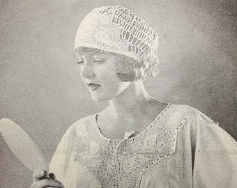 May include: A woman in a white crocheted nightgown and matching hat looks at herself in a hand mirror.