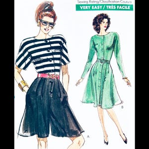 May include: A vintage sewing pattern featuring two women's outfits. The first outfit is a black and white striped top with black shorts. The second outfit is a green dress with long sleeves and a button-up front. The pattern is labeled "Very Easy/Très Facile".