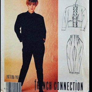 May include: A sewing pattern envelope for a French Connection outfit featuring a black long-sleeved jacket with a high collar and matching high-waisted trousers. The cover displays a line drawing of the jacket with ruffled trim and pleated pants.
