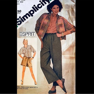 May include: A sewing pattern for a plaid shirt and high-waisted pants. The pattern is from Simplicity and is for size 6-8 and size 14-16. The pattern is for a women's outfit and is called "Esprit".