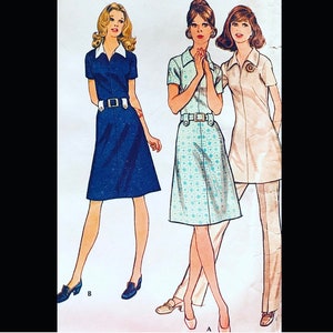May include: Three women wearing different styles of dresses. The woman on the left is wearing a blue dress with a white collar and a belt. The woman in the center is wearing a light blue and white patterned dress with a white collar. The woman on the right is wearing a white dress with a white collar and a belt. All three women are wearing white shoes.