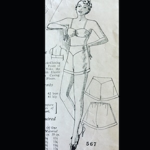 May include: A black and white sewing pattern illustration featuring a two-piece set with a strapless top and high-waisted shorts. The design includes a back-closing top with a front yoke and elastic casing. The text 567 is visible on the page.