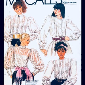 May include: Vintage McCall's sewing pattern featuring four blouse designs. The blouses have details like lace, puffed sleeves, and high collars. The pattern includes the text "EASY FIT" and "MADE-FOR-YOU".