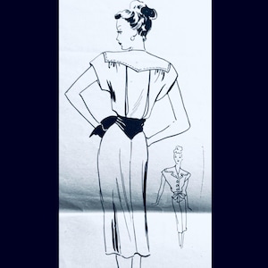 May include: A black and white line drawing illustration of a dress featuring a wide sailor-style collar, short sleeves, and a fitted waist with a dark sash tied at the back. A smaller, secondary sketch shows the front view with buttons down the bodice.