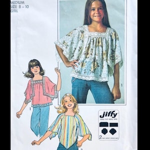 May include: A sewing pattern envelope for a Jiffy easy cut easy sew top in girl size medium 8-10. The pattern features illustrations of three tops with square necklines, wide sleeves, and lace trim, shown in floral, solid pink, and striped fabric designs.