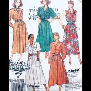 May include: Vintage sewing pattern featuring illustrations of collared dresses with pockets. The dresses are in various colors and patterns, including orange, green, and floral prints. The pattern includes the text "Fashion Basics" and "Cut-to-Fit".