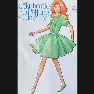 May include: A vintage sewing pattern featuring a woman wearing a green dress with a ruffled collar and short sleeves. The pattern is for sizes 18-24 and is from Authentic Patterns Inc.