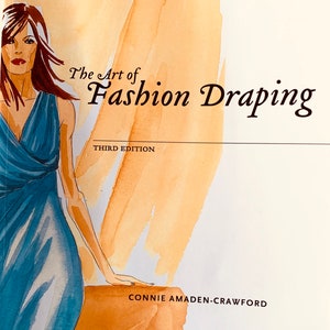 May include: The Art of Fashion Draping, Third Edition by Connie Amaden-Crawford. The cover features a watercolor illustration of a woman wearing a blue dress.