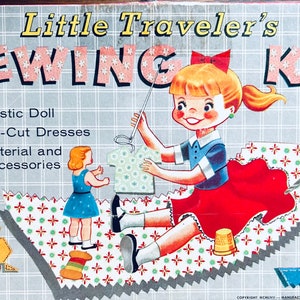 May include: A vintage sewing kit for children, featuring a plastic doll, die-cut dresses, and sewing materials. The box art shows a girl sewing a dress for her doll. The text on the box reads "Little Traveler's Sewing Kit" and "With Plastic Doll, Die-Cut Dresses, Material and Accessories."