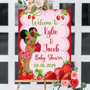 Puede incluir: Bienvenido a la fiesta de bienvenida al beb&eacute; de Kylie & Jacob, con un fondo rojo, texto rosa y blanco y una ilustraci&oacute;n de dibujos animados de una ni&ntilde;a negra sosteniendo una fresa. La fecha de la fiesta es el 08-05-2024.