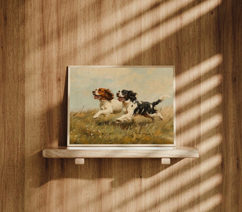 May include: A framed painting of two brown and white dogs running through a field of green grass. The dogs are running side by side, with their tongues out and their ears flapping in the wind.