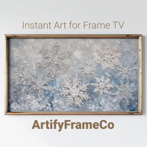 Puede incluir: Una pintura enmarcada de una escena de invierno con copos de nieve blancos sobre un fondo azul y blanco. El marco es dorado y la pintura se titula "ArtifyFrameCo".