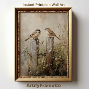 May include: A painting of two brown sparrows perched on a wooden fence post. The sparrows are surrounded by green foliage and white flowers. The painting is framed in a gold frame.