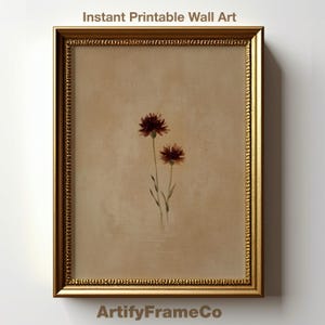 Peut inclure: Impression florale encadrée avec deux fleurs rouge foncé sur fond beige. Le cadre doré présente un motif orné. Le texte "Instant Printable Wall Art" est en haut et "ArtifyFrameCo" en bas. Idéal pour la décoration intérieure.
