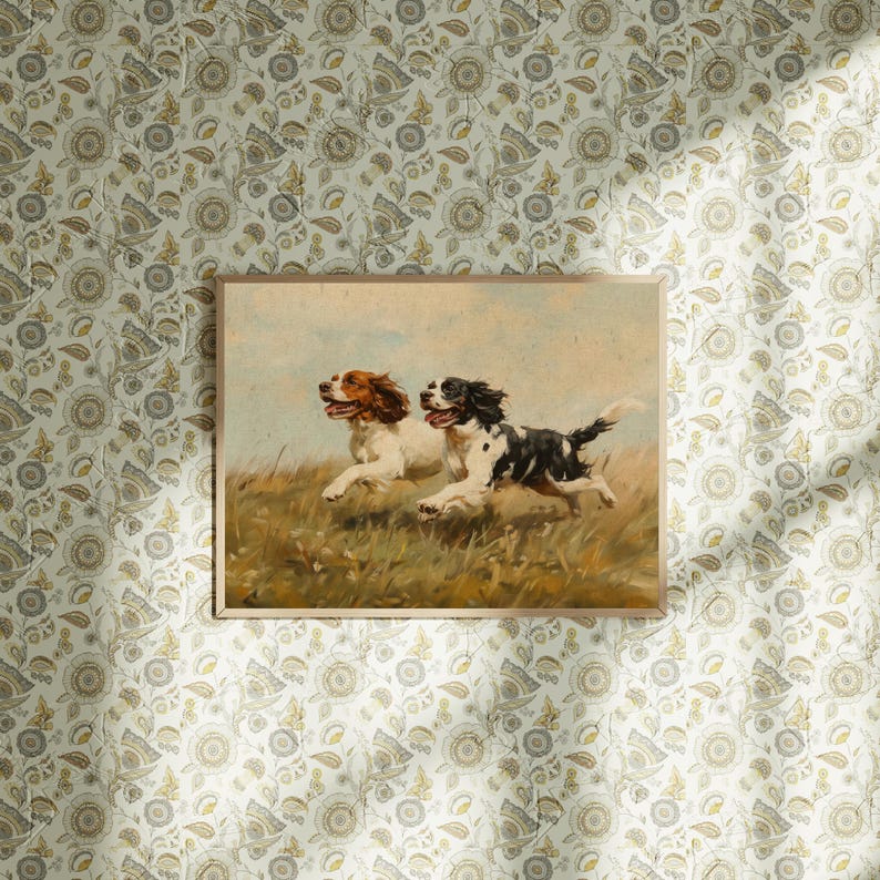 May include: A vintage painting of two Springer Spaniel dogs running through a field of tall grass. The dogs are brown and white with black markings. The painting is framed in a brown wooden frame.