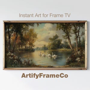 May include: A painting depicting a tranquil lake scene with swans gliding on the water. The lake is bordered by trees and greenery, and the sky is a gentle blue with white clouds. The painting is framed in a gold frame.