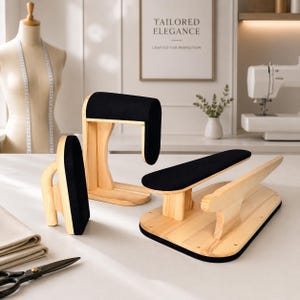 May include: A set of three wooden tailoring tools with black fabric padding, including a sleeve board, a pressing ham, and a clapper. These sewing accessories are designed for garment pressing and shaping, featuring natural light wood grain finishes.