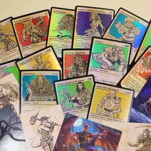 May include: A selection of fantasy-themed trading cards, showcasing illustrations of creatures and characters. The cards have a holographic finish and include text with names and descriptions. The cards are in various colours, including green, blue, and red.