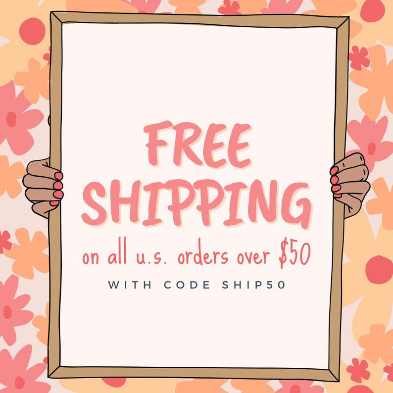 May include: A white sign with a pink frame and pink text that reads "FREE SHIPPING on all u.s. orders over $50 WITH CODE SHIP50". Two hands are holding the sign on either side.