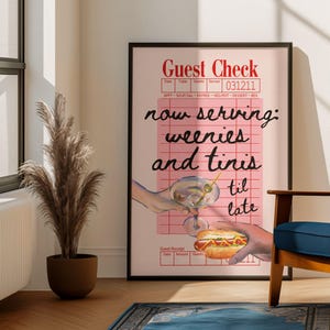 May include: A pink and white guest check with the text "now serving: weenies and tinis til late" in black. The check is on a black frame and there is a hand holding a martini glass and another hand holding a hot dog.