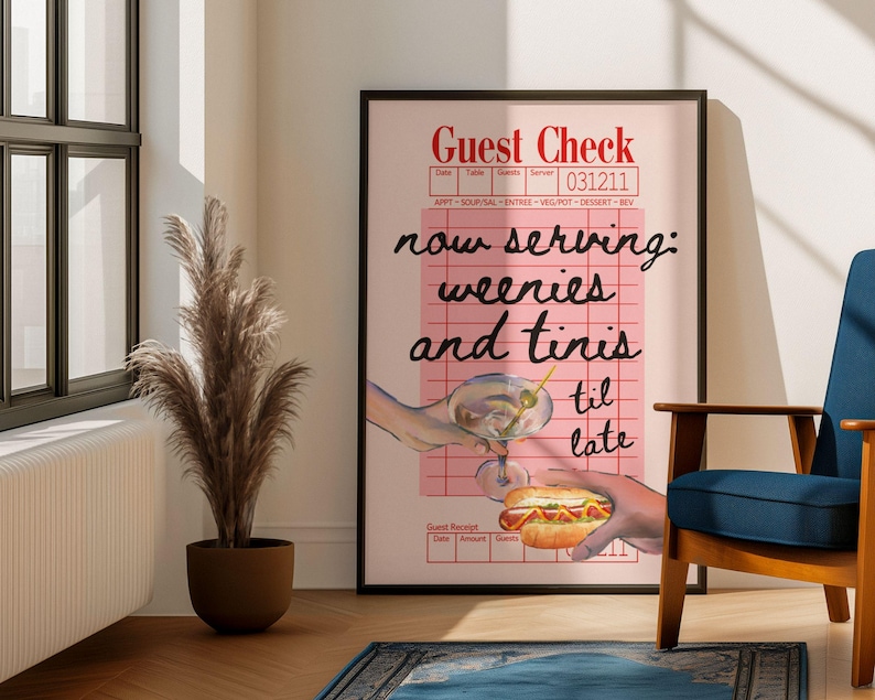 May include: A pink and white guest check with the text "now serving: weenies and tinis til late" in black. The check is on a black frame and there is a hand holding a martini glass and another hand holding a hot dog.