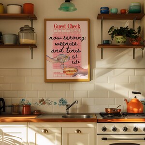 May include: A vintage-style poster with a pink background and the text "Guest Check now serving: weenies and tinis til late". The poster features a hand holding a hot dog and a glass of a pink drink.