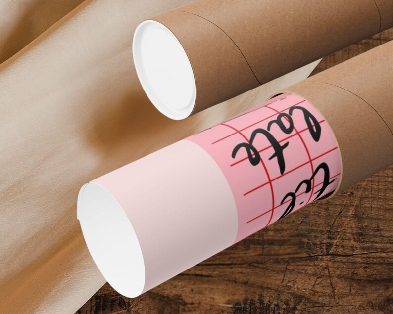 May include: A pink and white mailing tube with a red grid pattern and the text "Cafe" written in black. The tube is partially inside a brown mailing tube.
