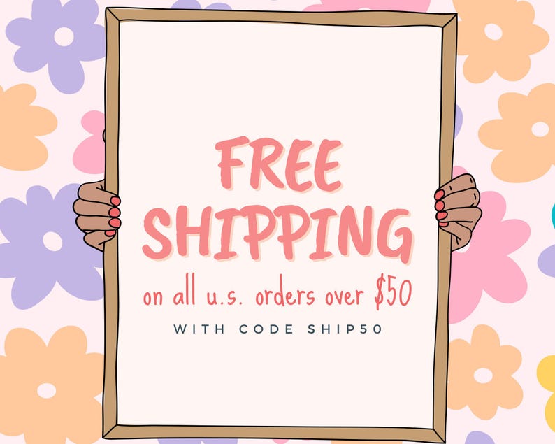 May include: A white sign with a brown frame held by two hands. The sign says "FREE SHIPPING on all u.s. orders over $50 WITH CODE SHIP50". The sign is against a pink background with colorful flowers.