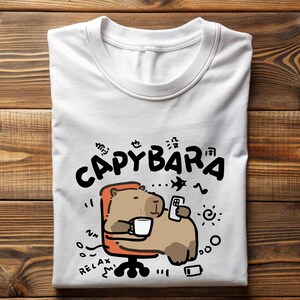 a white t - shirt with a cartoon bear holding a cell phone