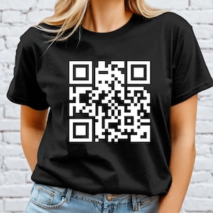 May include: Black t-shirt featuring a large white QR code design. The shirt is a classic crew neck style, made of a soft material. The QR code is a modern graphic element, suitable for various uses.