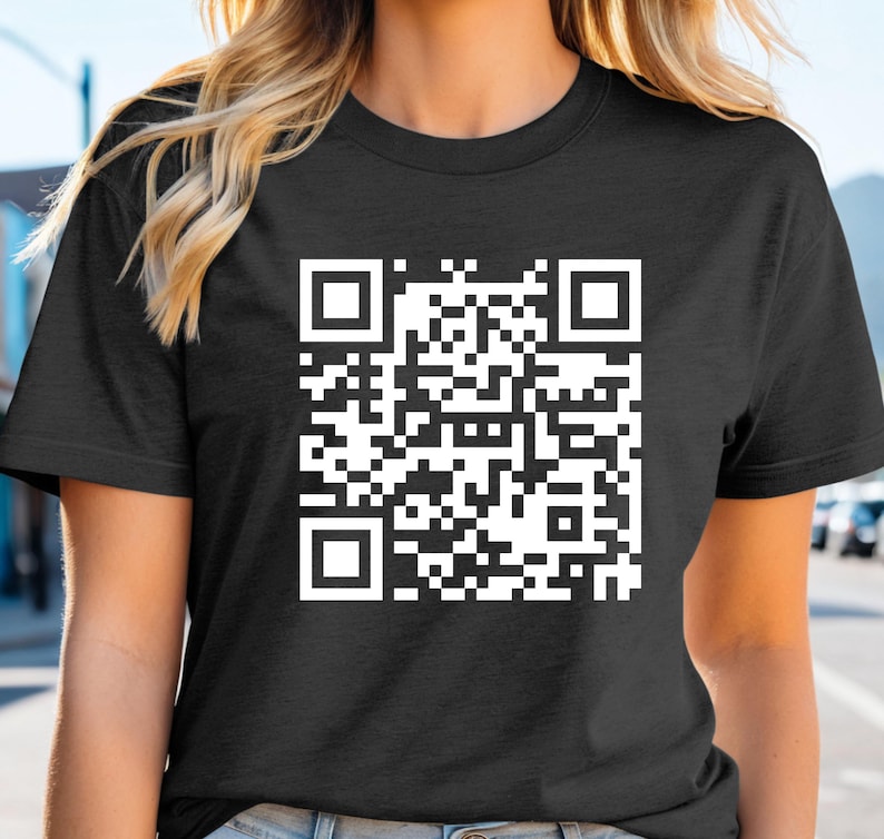 a woman wearing a black t - shirt with a qr code on it