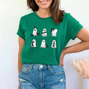 a woman wearing a green shirt with ghost on it