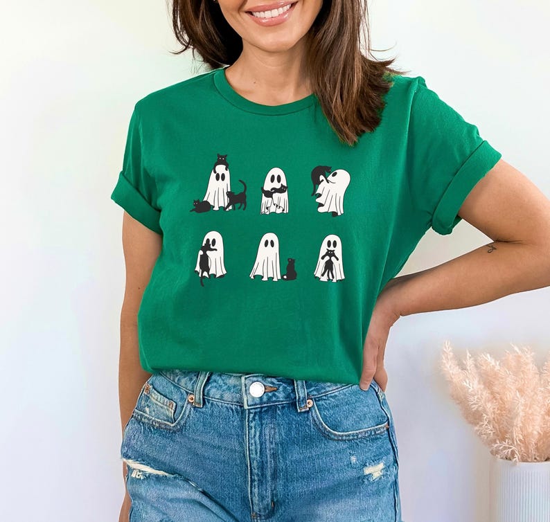 a woman wearing a green shirt with ghost on it