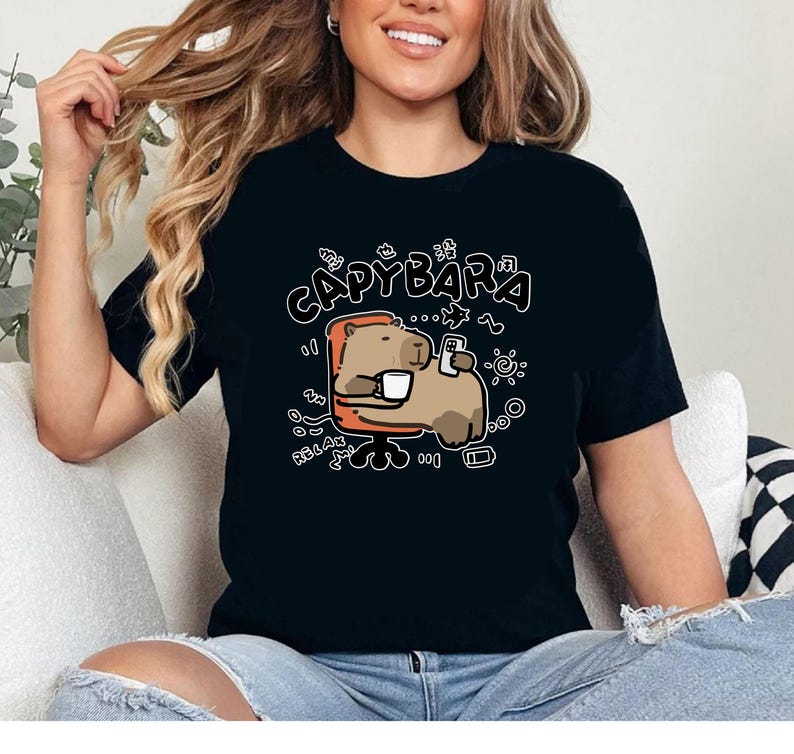a woman sitting on a couch wearing a black shirt