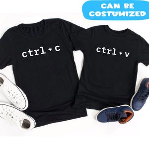 May include: Two black t-shirts with white text that reads "ctrl+c" and "ctrl+v". The shirts are paired with white sneakers and blue shoes. A blue banner at the top says "CAN BE COSTUMIZED".