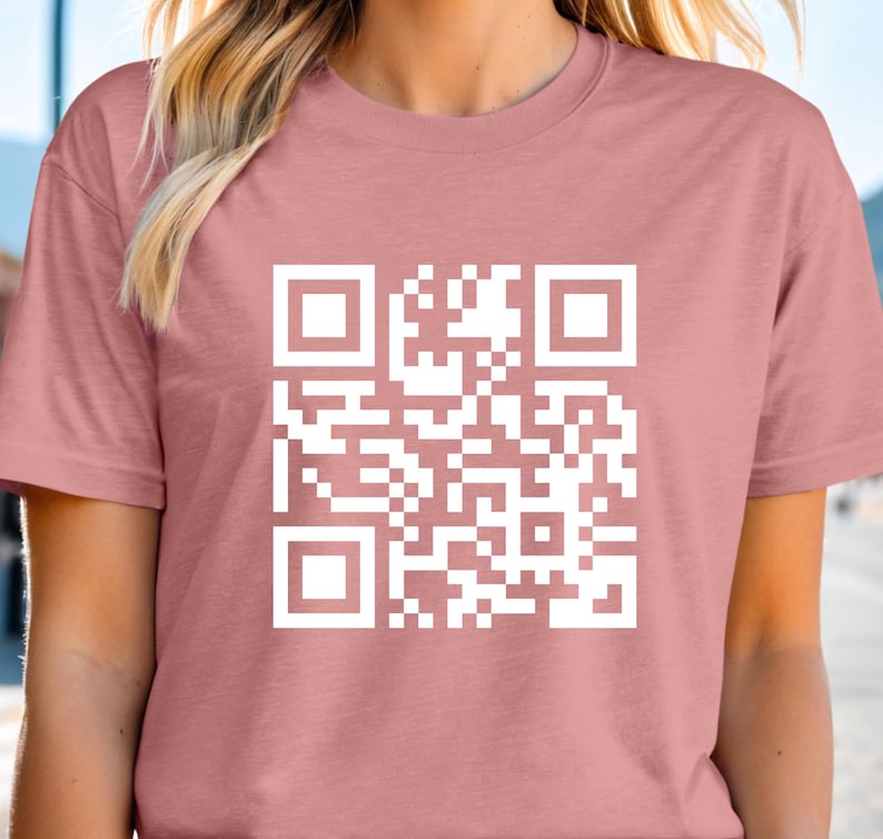 a woman wearing a pink shirt with a qr code on it