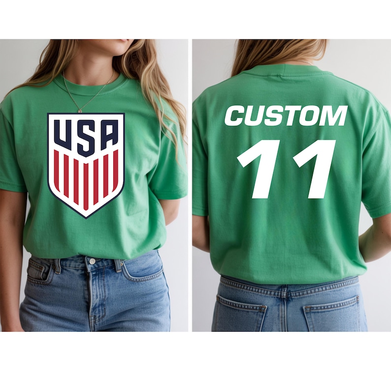A woman wearing a green t-shirt with a large shield logo and the number 11 on the back.