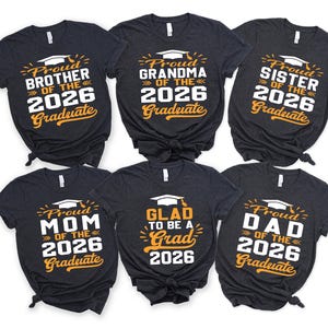 a collection of six black t-shirts with text and graphics printed on them, celebrating the graduation of the 26th of the year.